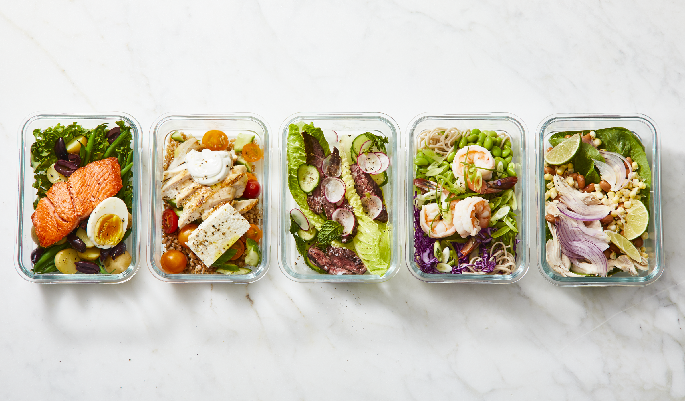 A row of meal-prepped dinners inside of containers